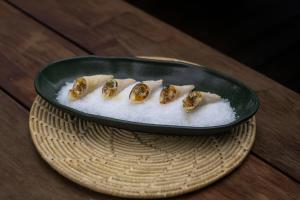 a plate of food on a wooden table at Carnaúba Hotel Boutique in Aquiraz