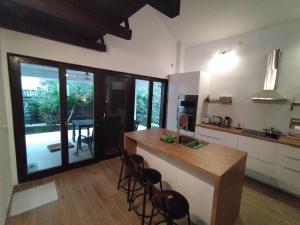 a kitchen with a counter and some chairs in it at Villa Terraca in Mandre +26 photos