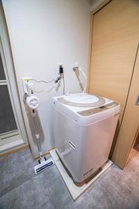 a bathroom with a toilet and a sink at New open! Dream ASUNARO 5 minuites from Shinsaibashi in Osaka