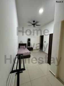 a bedroom with a bed and a ceiling fan at Home Away Homestay in Siliau +2 photos