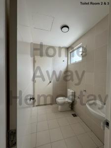 a bathroom with a toilet and a sink at Home Away Homestay in Siliau +2 photos
