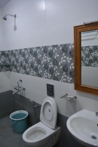 a bathroom with a toilet and a sink at Yanam resorts in Yanam