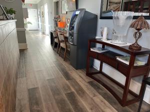 a kitchen with a hardwood floor and a refrigerator at Beau Rivage Golf and Resort in Myrtle Grove
