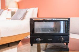 a toaster oven sitting on a table in a room at New open! Dream ASUNARO 5 minuites from Shinsaibashi in Osaka