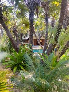 a resort with palm trees and a swimming pool at Sandy Feet Retreat in Malindi