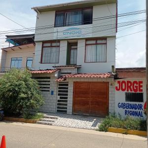 a large white house with a garage at rentapartBDSH in Tarapoto +21 photos