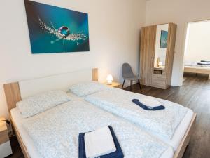 a bedroom with a bed and a mirror at Ferienwohnung Alte Sensenschärferfabrik in Franken Vorstadt +10 photos