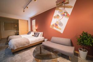 a bedroom with a bed and a chair and a table at New open! Dream ASUNARO 5 minuites from Shinsaibashi in Osaka