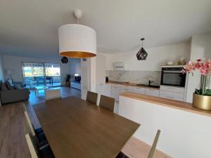 a kitchen and living room with a table and a dining room at Charmant 3 pièces vue mer in Antibes +2 photos