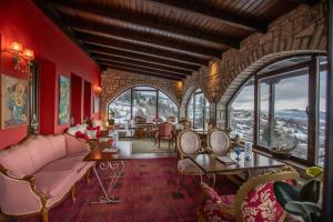 a living room with red walls and large windows at Archontiko Zakoni in Neochori