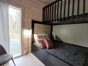 a bedroom with a loft bed with two pillows at Saga Tarula in Kuusamo