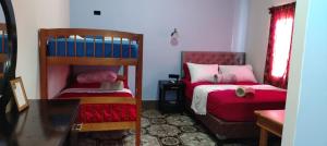 a bedroom with two bunk beds and a couch at Casa Victoria in San Benito +8 photos