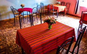 a table with a vase of flowers on it at Orlando Guest Resort in Machakos