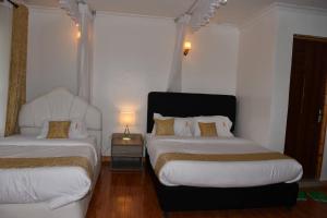 Postel nebo postele na pokoji v ubytování Tawala Garden Hotel