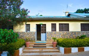 a house with a door and stairs in front of it at Orlando Guest Resort in Machakos