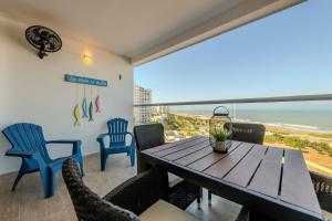 a dining room with a table and chairs and the ocean at Cartagena Beach Resort 807 in Cartagena de Indias