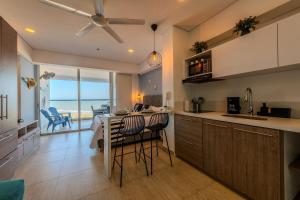 a kitchen with a table and chairs in a room at Cartagena Beach Resort 807 in Cartagena de Indias
