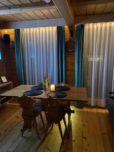 a dining room with a wooden table and chairs at Domek w górach in Nowy Targ