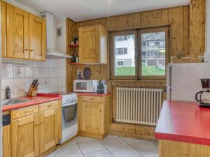a kitchen with wooden cabinets and a white refrigerator at Appartement 3 pièces à Megève Jaillet, 6 pers., balcon sud, garage, proche télécabine - FR-1-453-226 in Megève +2 photos