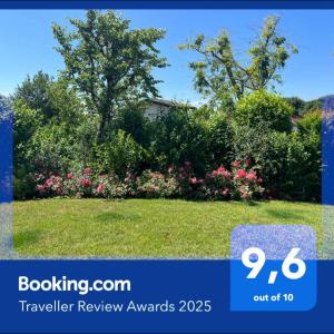 a picture of a yard with flowers and bushes at Steba House Savani Barbara Foresteria Lombarda in Lonato del Garda