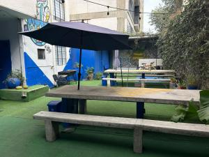 an umbrella sitting on top of a picnic table at BluePepper City Hostel in Guadalajara