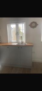 a kitchen counter with a sink and a window at Chestnut Cottage in Great Ellingham +42 photos