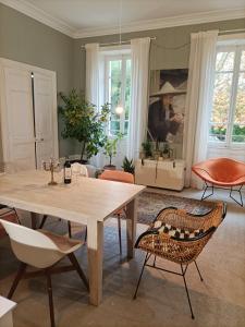 a living room with a table and chairs at Eine Magnanerie in der Provence in Bouchet +24 photos
