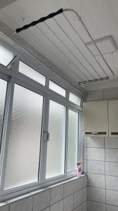a bathroom with a window in a room at Apto amplo próximo Casa Grande Hotel Resort in Guarujá