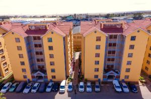 an aerial view of a apartment complex with cars parked in a parking lot at Adriel Stay in Nairobi