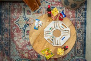 a round wooden table with food and drinks on it at Layali Properties - Vibrant Boho 3BR Apt - Convention and Exhibition Center in Riyadh +21 photos