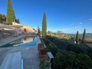 a villa with a swimming pool and a house at La Bergerie St Antoine in Spéracèdes