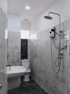 a bathroom with a toilet and a sink and a shower at Maijom Apartments in Jomtien Beach