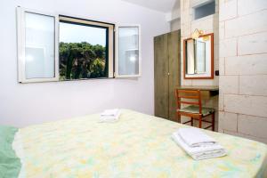 a bedroom with a bed and a window at Residence Atenaion in Otranto