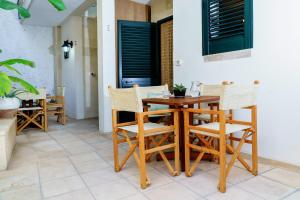 a dining room with a wooden table and chairs at Residence Atenaion in Otranto