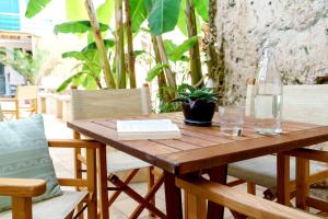 a wooden table with a bottle and a book on it at Residence Atenaion in Otranto