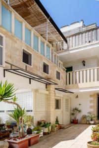 an external view of a building with plants at Residence Atenaion in Otranto