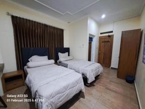 Ein Bett oder Betten in einem Zimmer der Unterkunft Cipada Guesthouse syariah