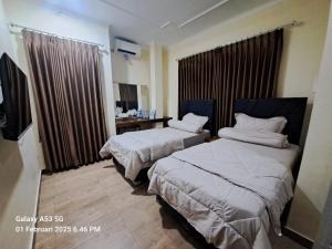 Ein Bett oder Betten in einem Zimmer der Unterkunft Cipada Guesthouse syariah