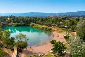 a view of a lake with people on the beach at Claude et chris536 in La Roque-dʼAnthéron