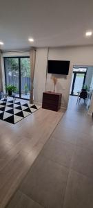 a living room with a couch and a tv on the wall at Yla Studio- Piatra Neamț in Piatra Neamţ