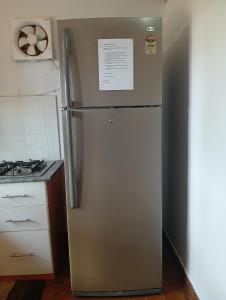 a refrigerator in a kitchen next to a stove at Jass luxury stays in Anjuna