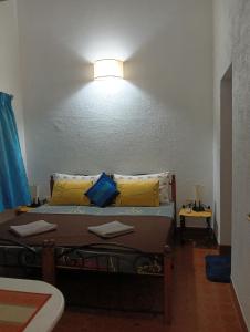 a bedroom with a bed with a light on the wall at Jass luxury stays in Anjuna +24 photos