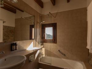 a bathroom with a sink and a tub and a shower at Es Petit de Valldemossa in Valldemossa