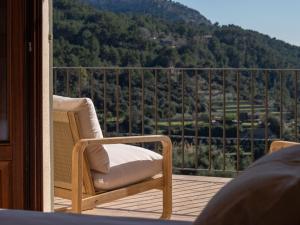 a chair on a balcony with a view of a mountain at Es Petit de Valldemossa in Valldemossa