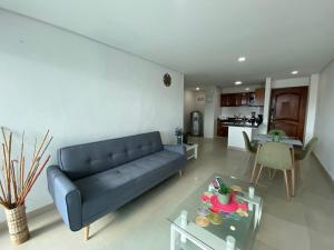 a living room with a blue couch and a table at Laguito Apartment in Cartagena de Indias