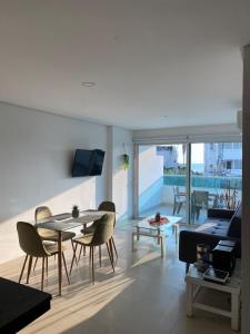 a living room with a table and chairs and a couch at Laguito Apartment in Cartagena de Indias
