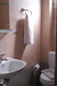 a bathroom with a sink and a toilet at Hotel Paros in Parikia