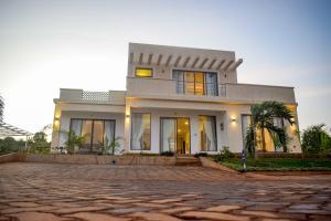a large white house with a stone driveway at PV104 Pazuri Haven in Kilifi
