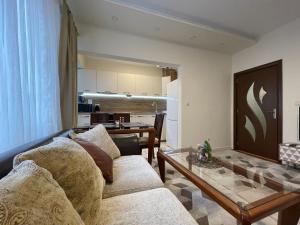 a living room with a couch and a table at Apartment The Room in Burgas