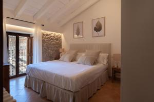 a bedroom with a white bed in a room at Es Petit de Valldemossa in Valldemossa